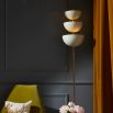 A luxurious floor standing lamp with ivory metal, polished brass and a marble base