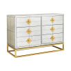 A luxurious six-drawer brass and antiqued mirror glass chest