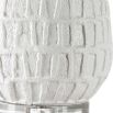 A modern side lamp with a textured white ceramic base and luxury linen shade