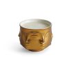 Golden ceramic candle by Jonathan Adler with faces 