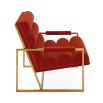 A mid-century modern inspired armchair with burnt orange velvet and a polished brass frame