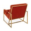 A mid-century modern inspired armchair with burnt orange velvet and a polished brass frame