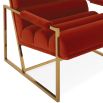 A mid-century modern inspired armchair with burnt orange velvet and a polished brass frame