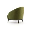 An elegant, deep-buttoned velvet armchair with metal accents