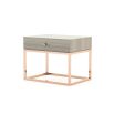 A modern grey bedside table with a gold base and details
