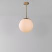 Industrial style glass globe pendant made entirely of solid brass and handblown glass globes with a natural brass finish