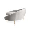 A gorgeous grey velvet sofa on brass legs.