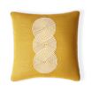 Playful yellow cushion with swirling pattern