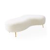 Organic shaped upholstered ottoman with tapered brass legs