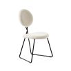 Stylish dining chair upholstered in white fabric with a sleek black frame