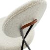 Stylish dining chair upholstered in white fabric with a sleek black frame