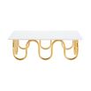 Luxurious coffee table with wave effect legs in polished brass finish