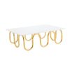 Luxurious coffee table with wave effect legs in polished brass finish
