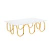 Luxurious coffee table with wave effect legs in polished brass finish