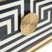 Modernist inspired poppy sideboard with brass accents and black and white pattern