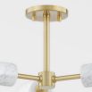 A chic white marble and aged brass dual globe wall lamp