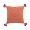 Luxuriously cosy orange cushion with orange tassels 