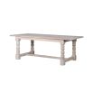 A large classic dining table made from mahogany with a white wash finish
