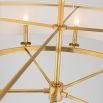 An elegant oval ceiling pendant in aged brass with an off-white linen lampshade 