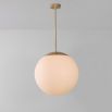 Industrial style glass globe pendant made entirely of solid brass and handblown glass globes with a natural brass finish