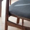 Retro inspired dining chair with grey fabric and walnut stained wooden frame