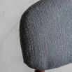 Retro inspired dining chair with grey fabric and walnut stained wooden frame