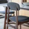Retro inspired dining chair with grey fabric and walnut stained wooden frame