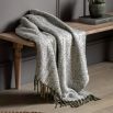 Green herringbone throw with green tassels 