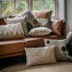 Square cushion with yellow and black circular and striped abstract design