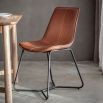 Scooped brown leather chair with black metal legs