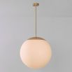 Industrial style glass globe pendant made entirely of solid brass and handblown glass globes with a natural brass finish