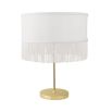 a fabulous golden table lamp with a tasselled white lampshade