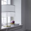 a fabulous golden table lamp with a tasselled white lampshade