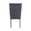 A set of two grey velvet buttonback dining chairs with whitewashed wooden legs 