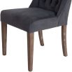 A set of two grey velvet buttonback dining chairs with whitewashed wooden legs 