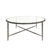 A luxurious round wood or metal coffee table with a clear glass surface