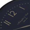 A classic styled, black wall clock with gold details