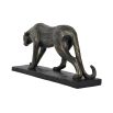 A statement sculpture of a leopard with a textured bronze finish 