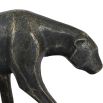 A statement sculpture of a leopard with a textured bronze finish 