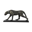 A statement sculpture of a leopard with a textured bronze finish 