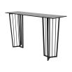 Black metal console table with geometric legs and tinted glass top