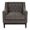 Cosy armchair with deep buttoning on the backrest and grey upholstery