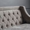 Luxury grey sofa with deep studding details and curved arms