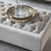 Simple ottoman with deep buttoning details on the seat