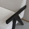 Sleek boucle upholstered sofa with black arm rests