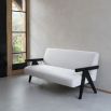 Sleek boucle upholstered sofa with black arm rests