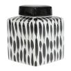 delicately painted jar with black patterned streaks. 