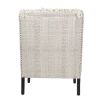 Textured upholstered armchair with tassels and black wooden legs