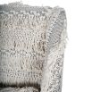 Textured upholstered armchair with tassels and black wooden legs