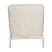 wooly upholstered armchair with washed wood frame